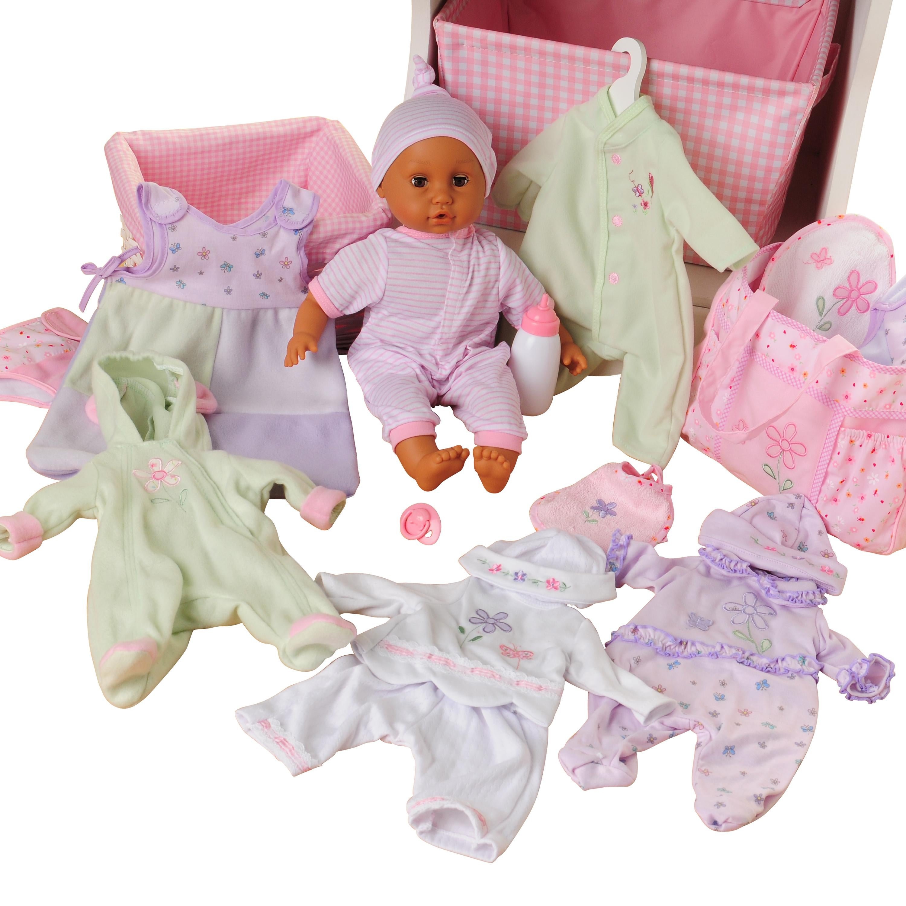 A doll play set with a baby doll wearing a pink striped onesie and hat, surrounded by matching pink, purple, and green baby clothes, a pink gingham storage basket, and a pink diaper bag on a white background.