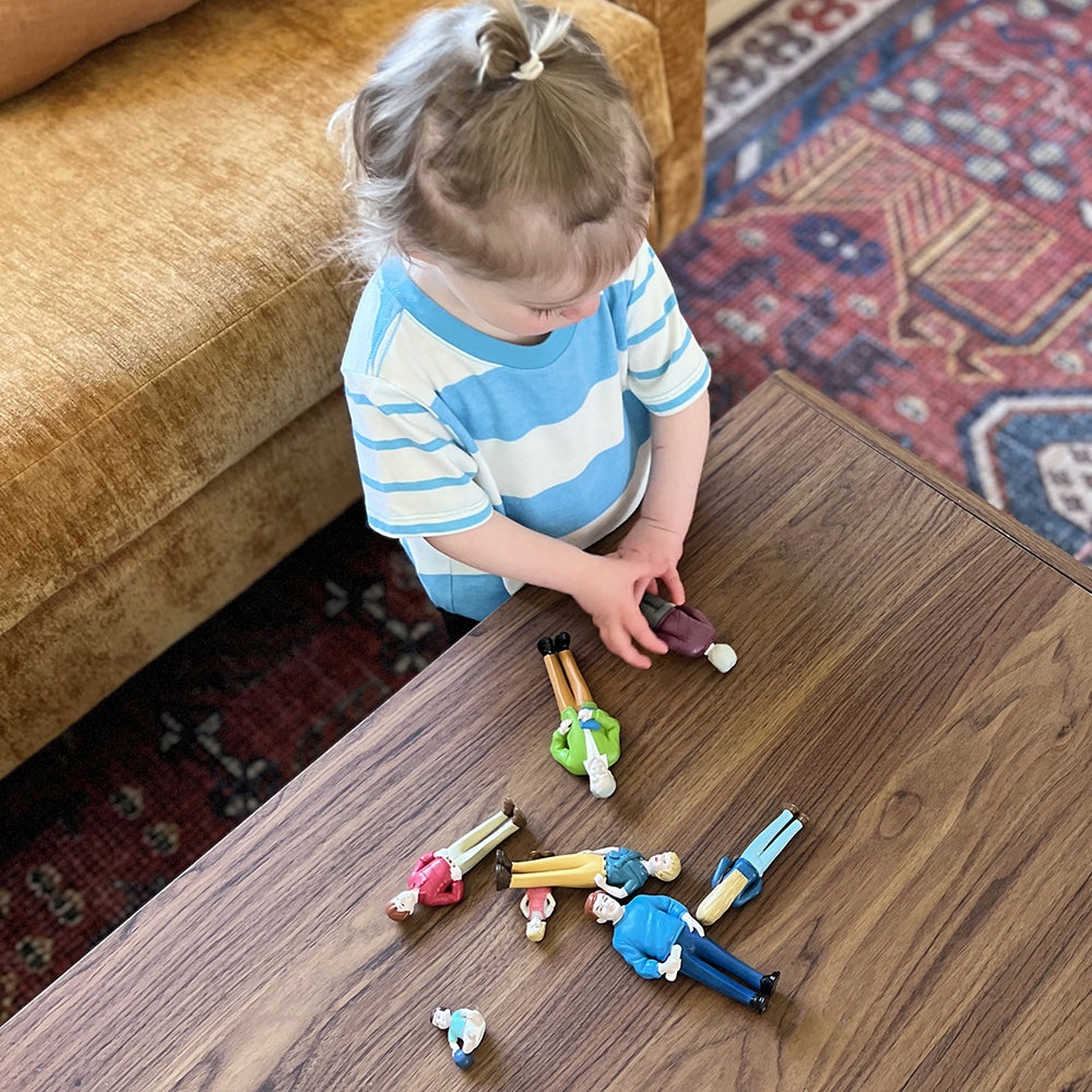 Toddler Playing with Pretend Play Family Figures