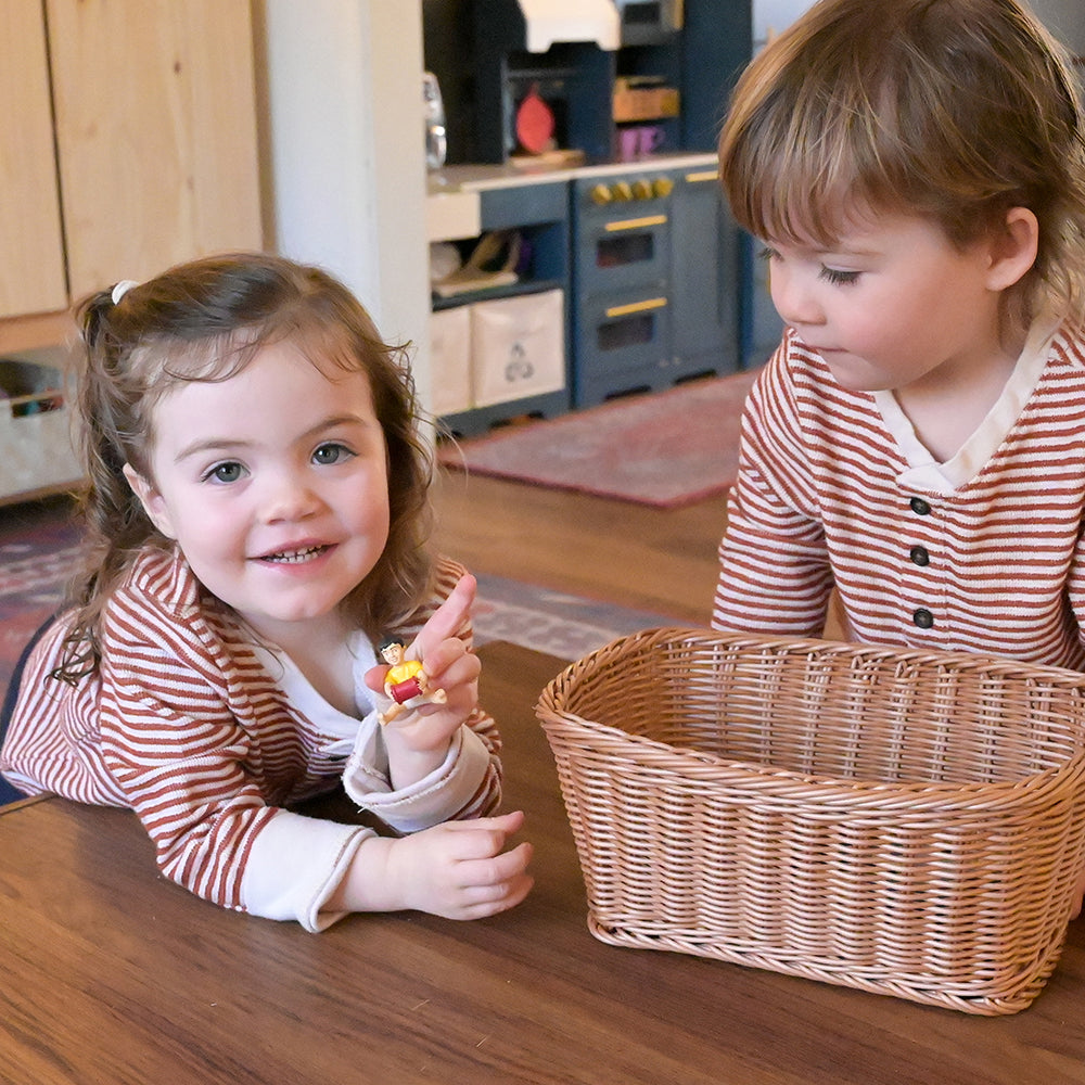 Two Toddlers Playing with Asian Pretend Play Vinyl Family Figurines