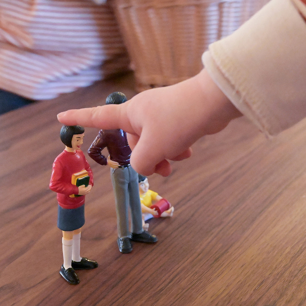 Close-up of Two Asian Pretend Play Vinyl Family Figurines