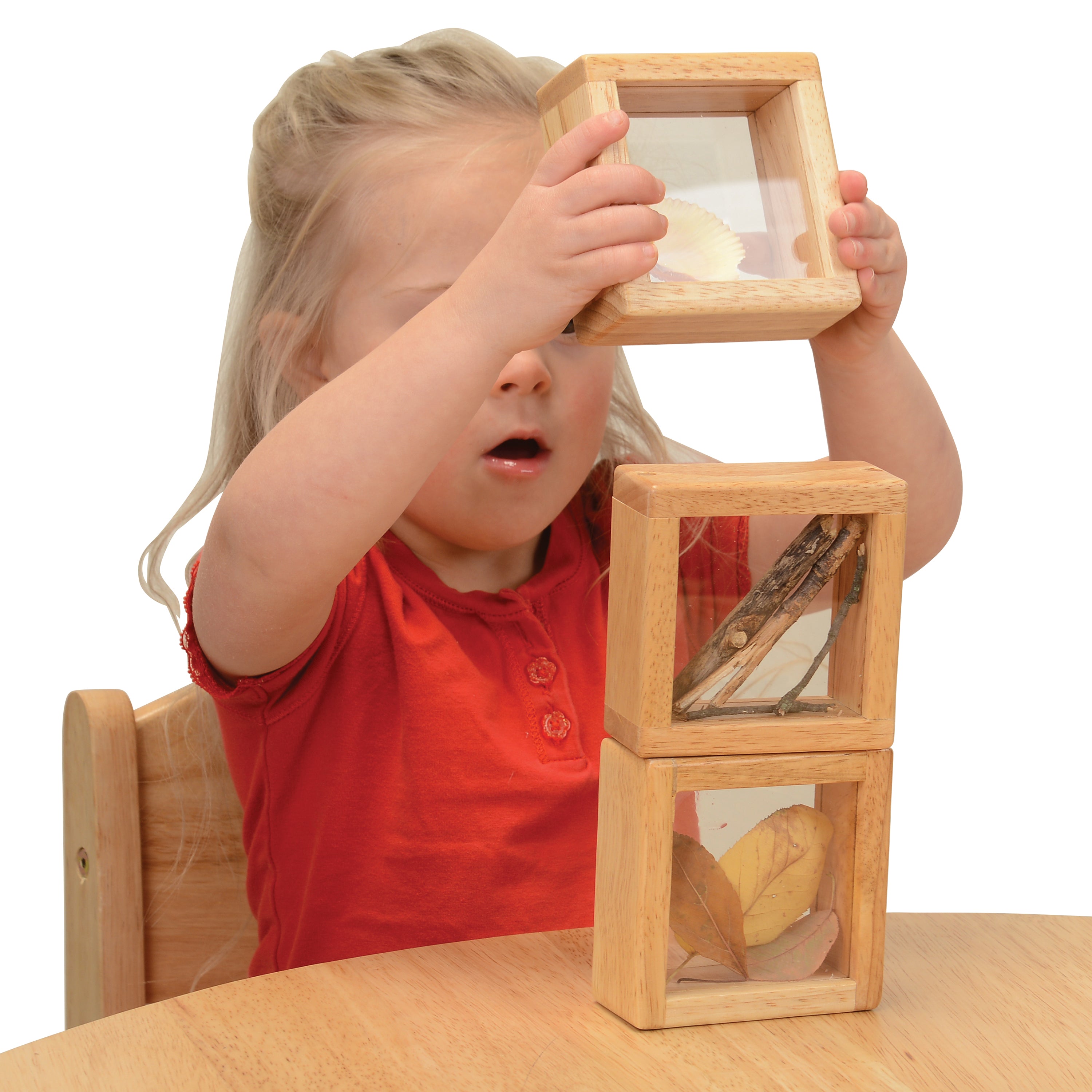 Child playing with wooden blocks on a white background