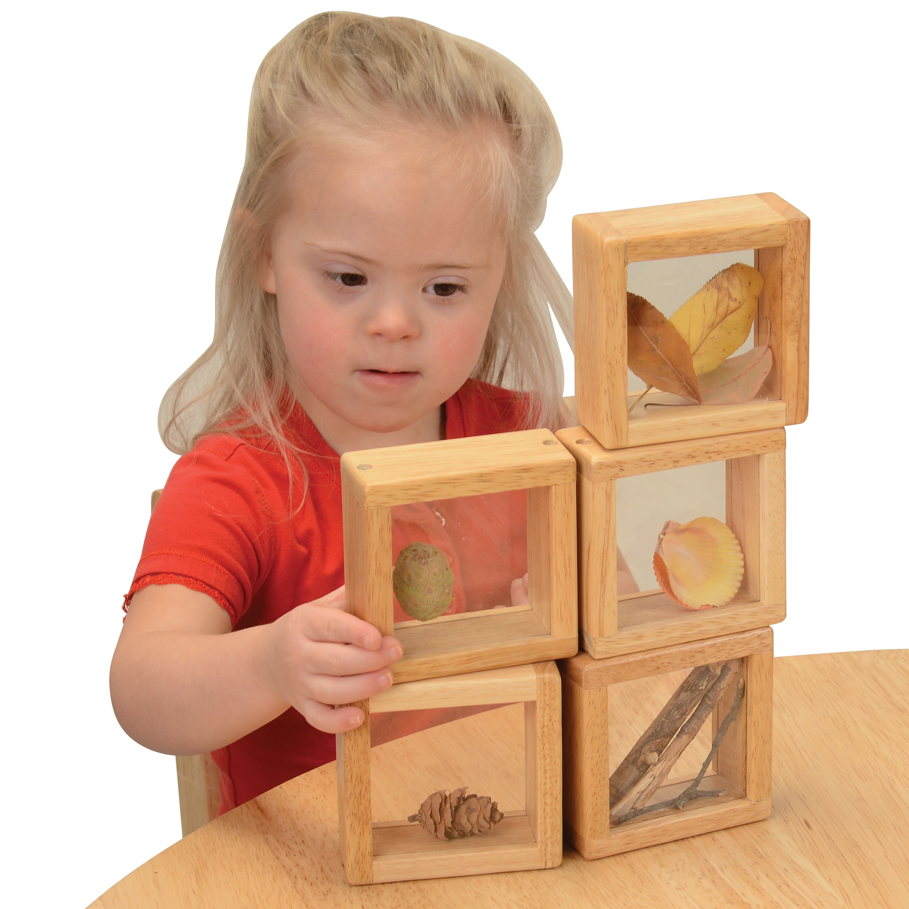 Child playing with wooden blocks on a table