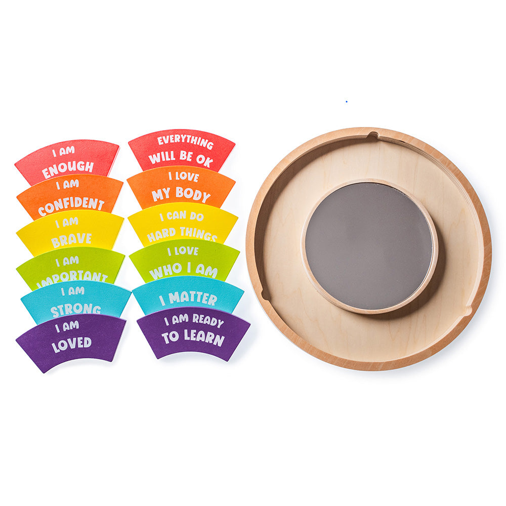Set of colorful affirmation cards and a wooden mirror on a white background
