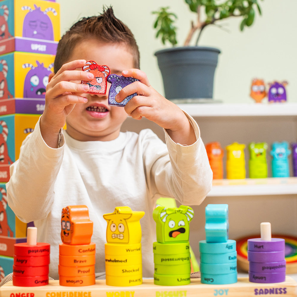 Child playing with colorful toy blocks in a playful indoor setting
