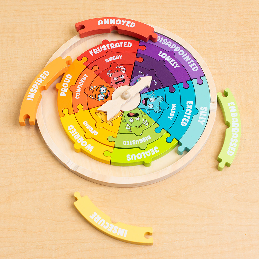 Colorful emotion wheel puzzle on a wooden surface
