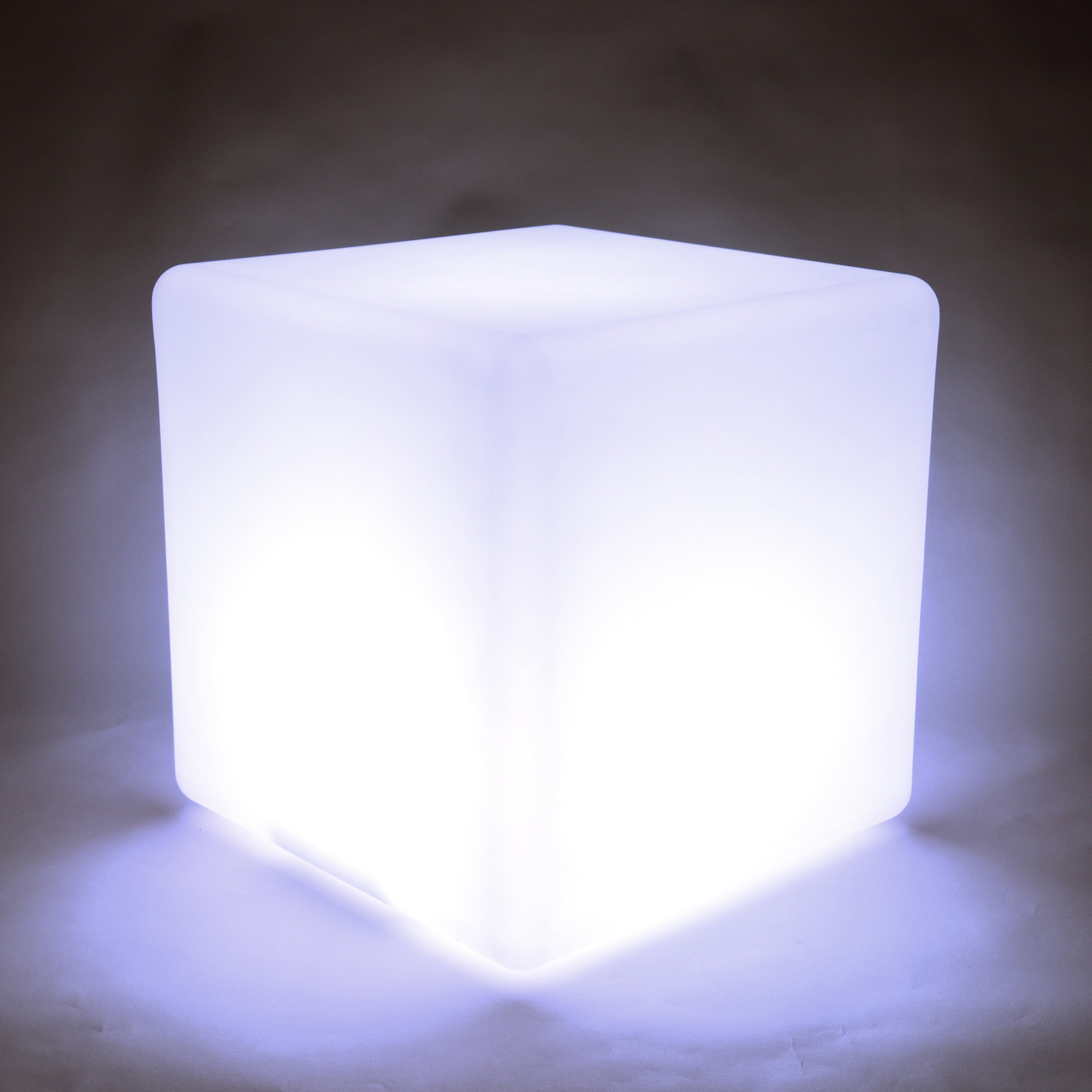 Cube-shaped light emitting a bright white glow on a dark background