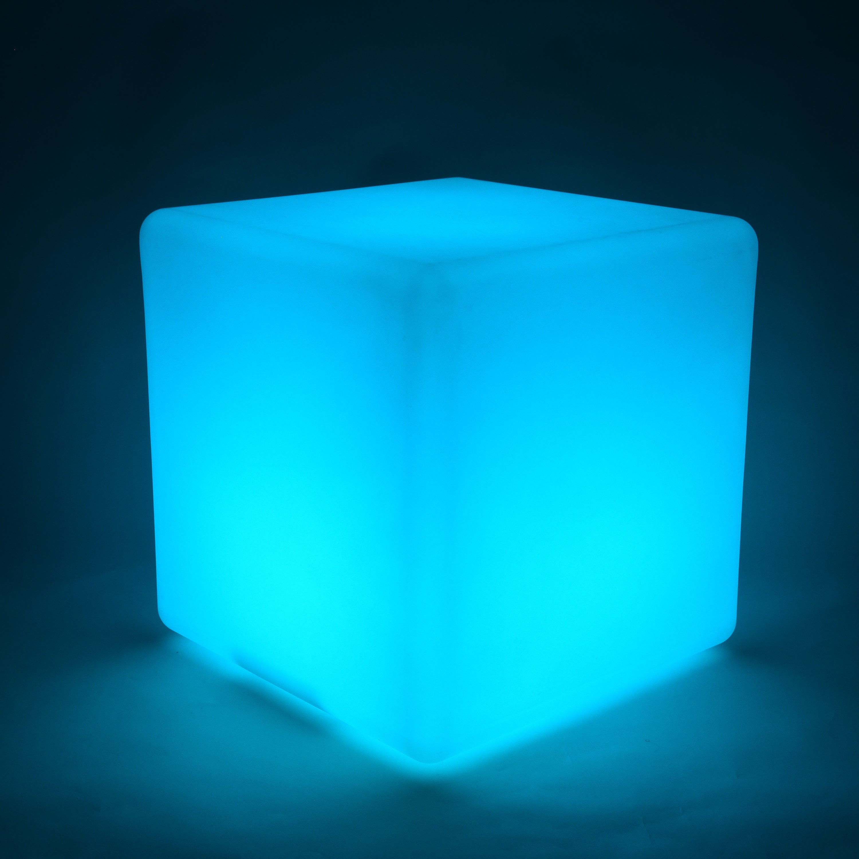 Cube-shaped illuminated object glowing blue on a dark background