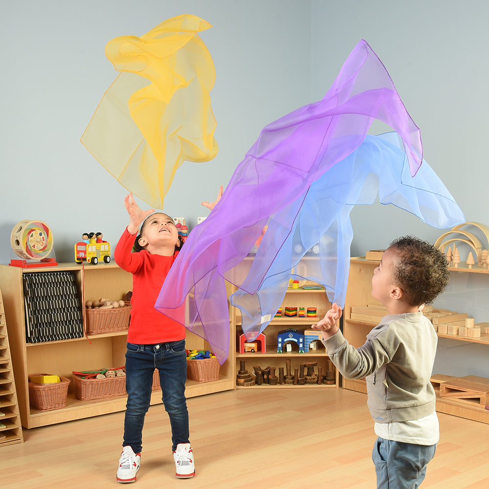 Toddlers Playing with Rainbow Scarves in the Classroom