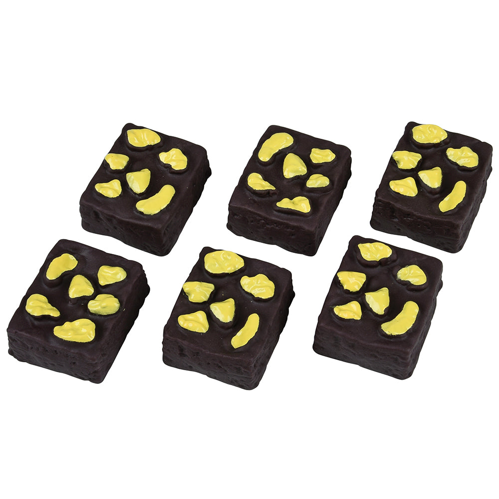 Chocolate treats with yellow accents arranged on a white background