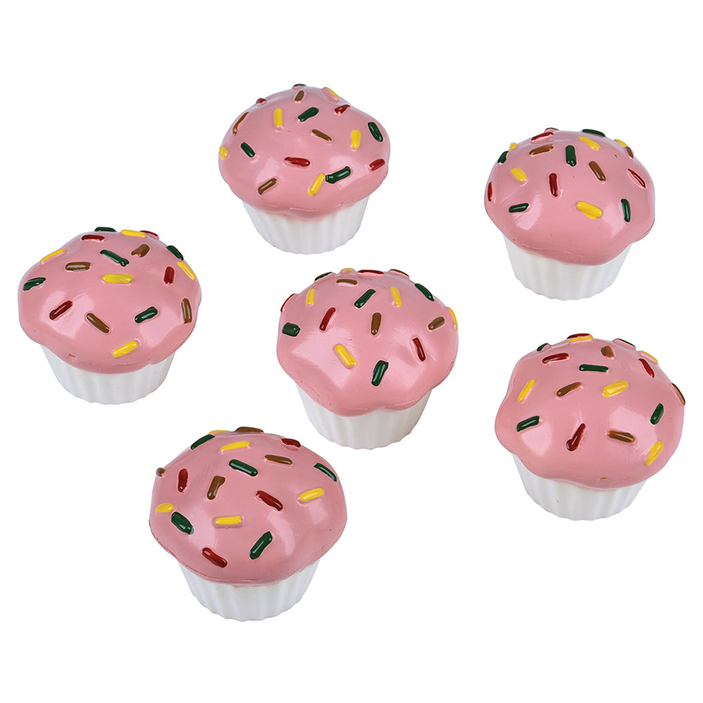 Pink toy cupcakes with sprinkles on a white background