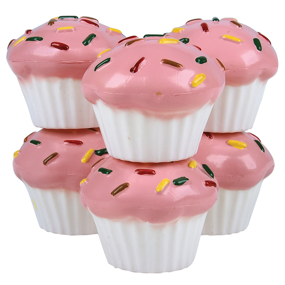 Pink toy cupcakes with colorful sprinkles on a white background