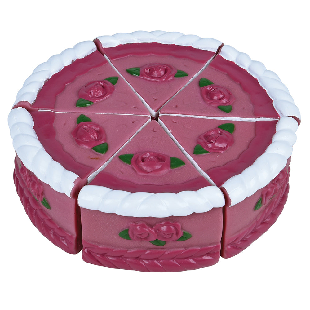 Pink toy cake with white frosting and rose decorations on a white background