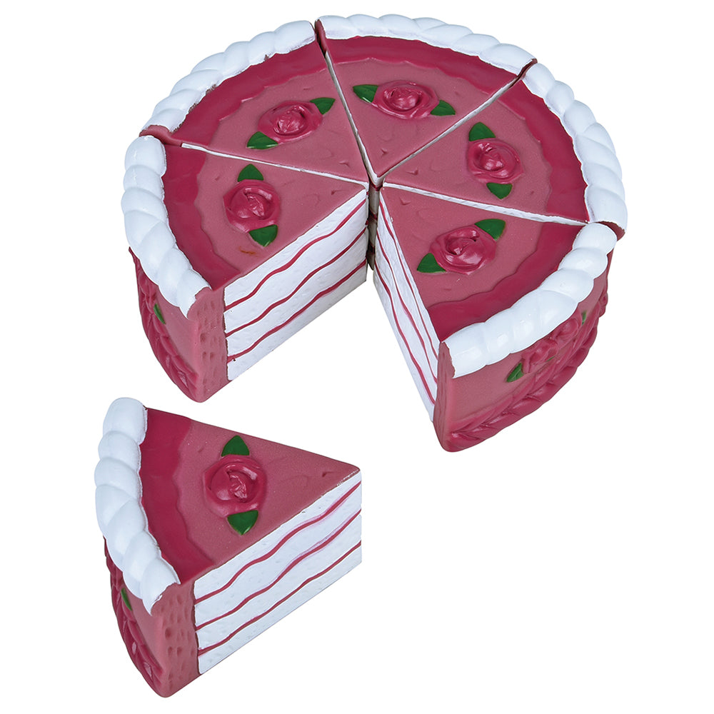Pink toy cake with a slice removed on a white background