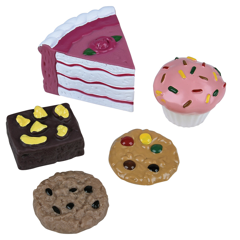 Set of toy desserts including a slice of cake, cupcake, brownie, and cookies on a white background
