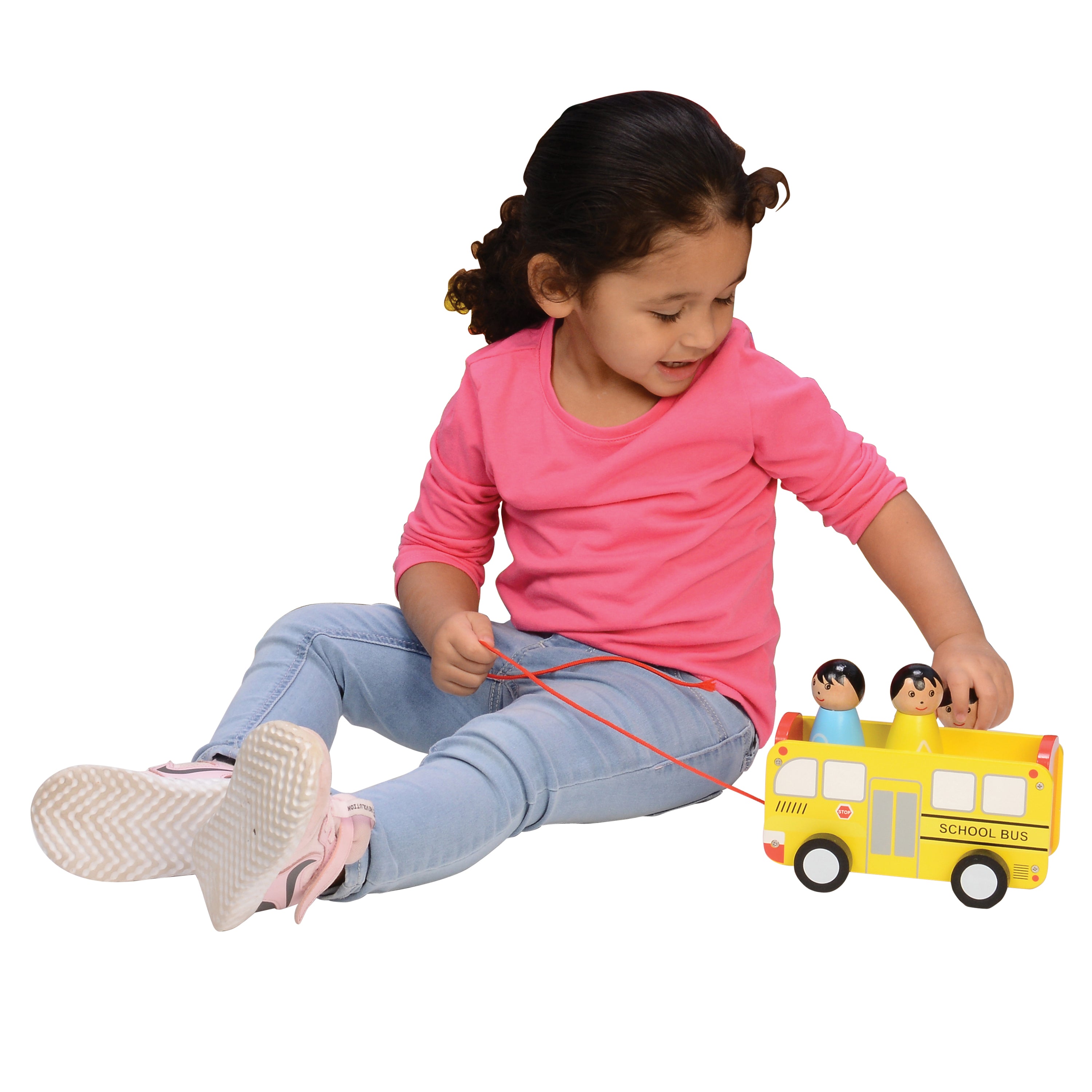 Child playing with a toy school bus on a white background