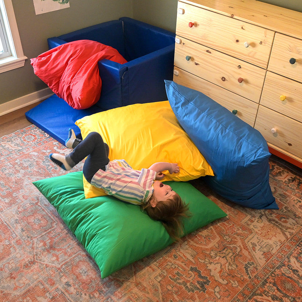 Toddler Being Playful with Giant Cuddly Pillows