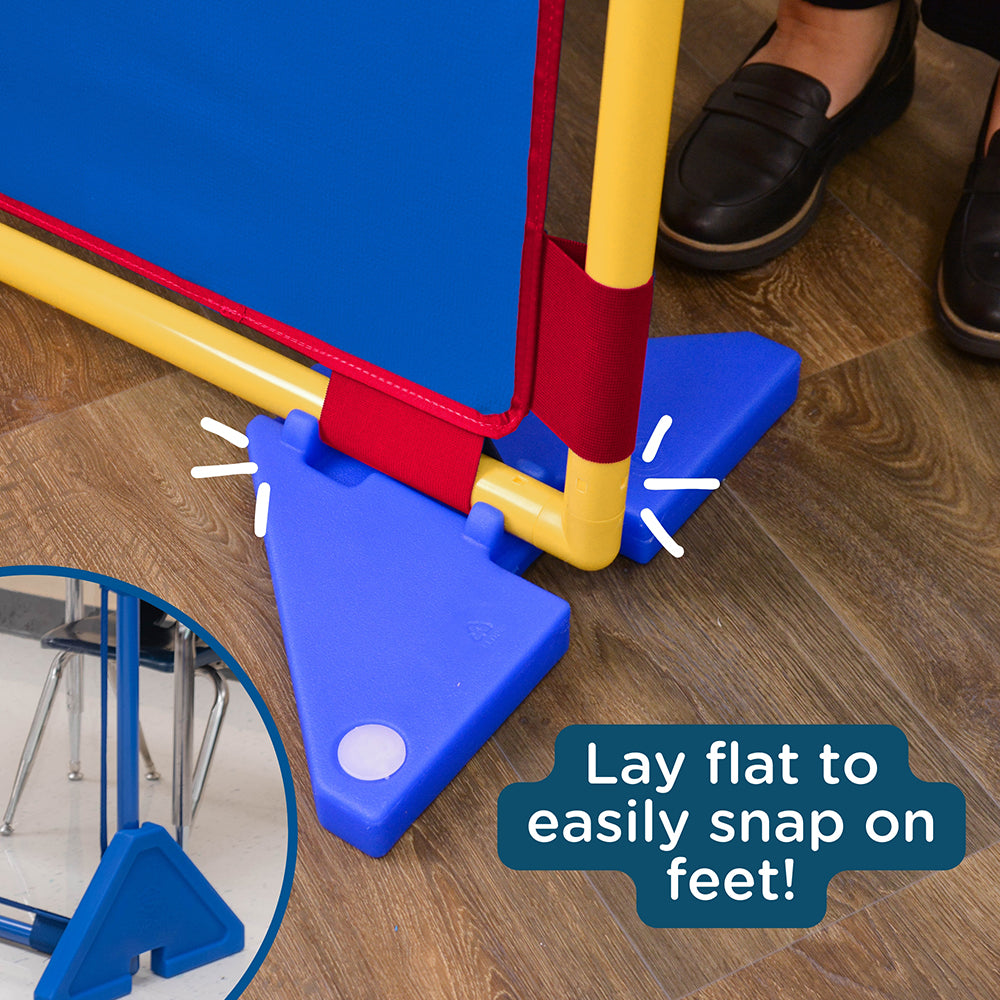 Colorful plastic stand with blue base on a wooden floor, labeled 'Lay flat to easily snap on feet'.