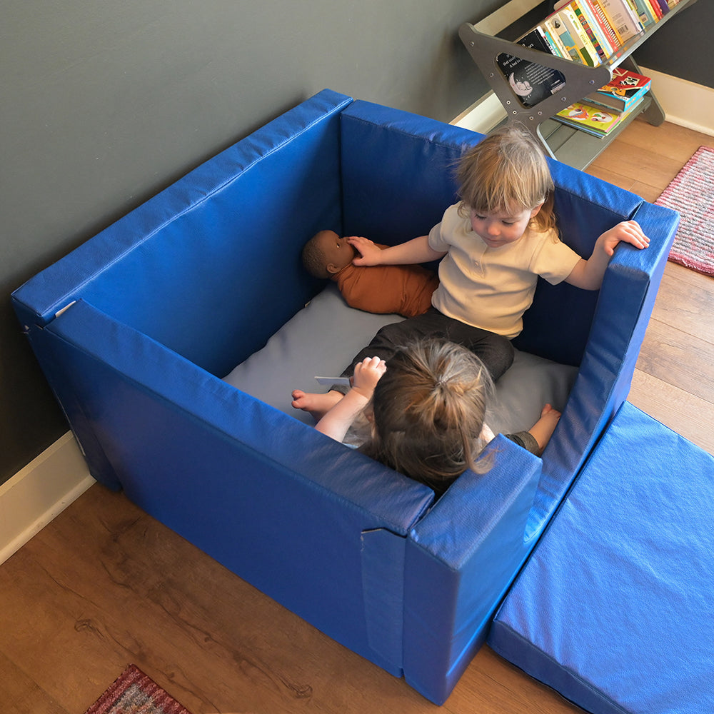 Two Toddlers Enjoying a Calm Moment in Cozy Cube