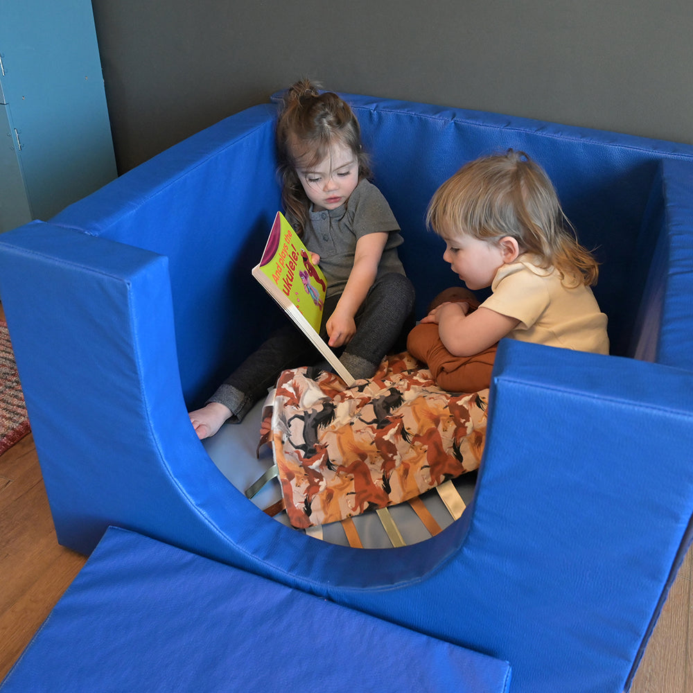 Toddlers Enjoying Reading Time in Cozy Cube