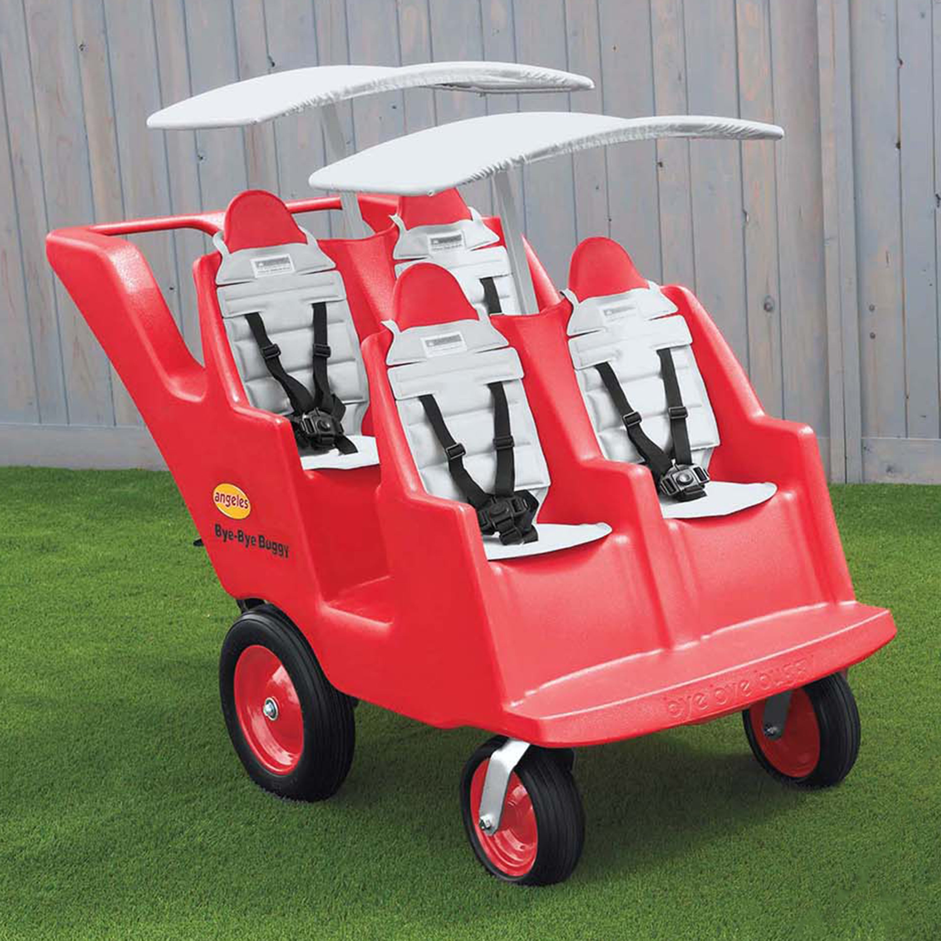Red children's wagon with multiple seats on a grassy area