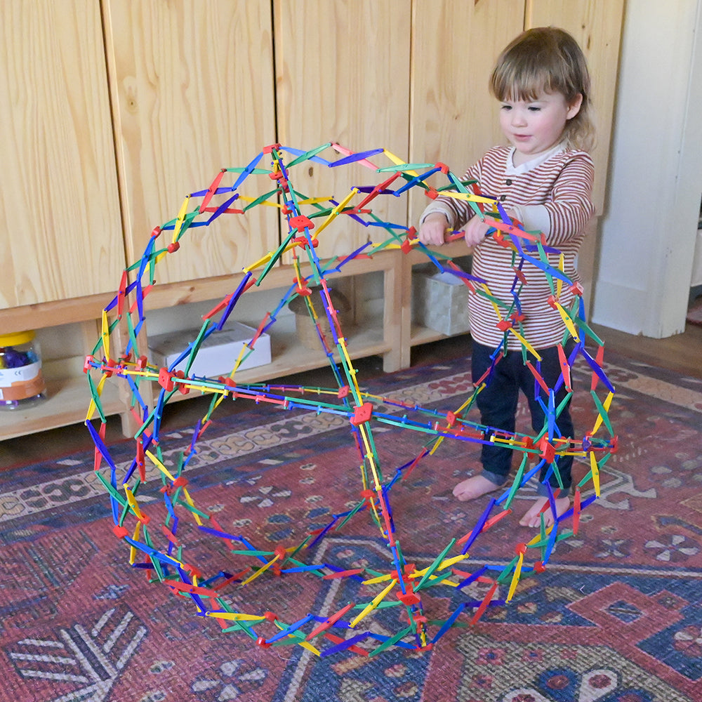 Toddler Using Rainbow Hoberman Sphere