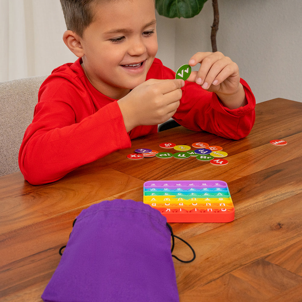 Kid Studying Letter Tile for ABC Pop & Match Bingo 