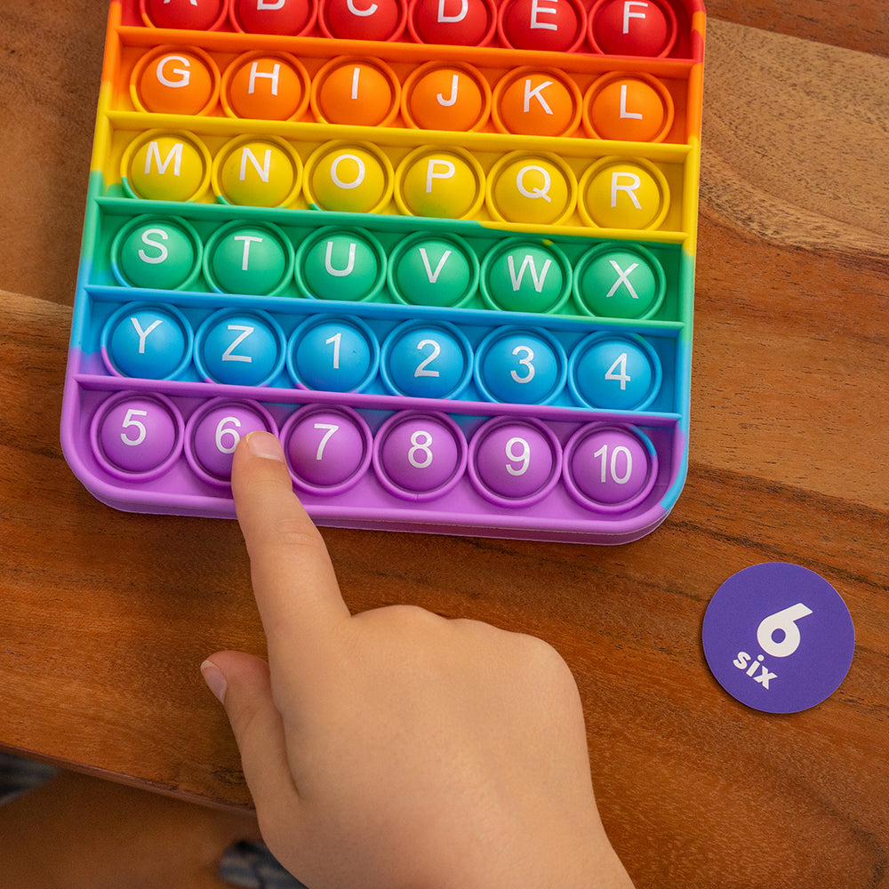 Kid Matching 6 Tile to Number 6 on Fidget Board