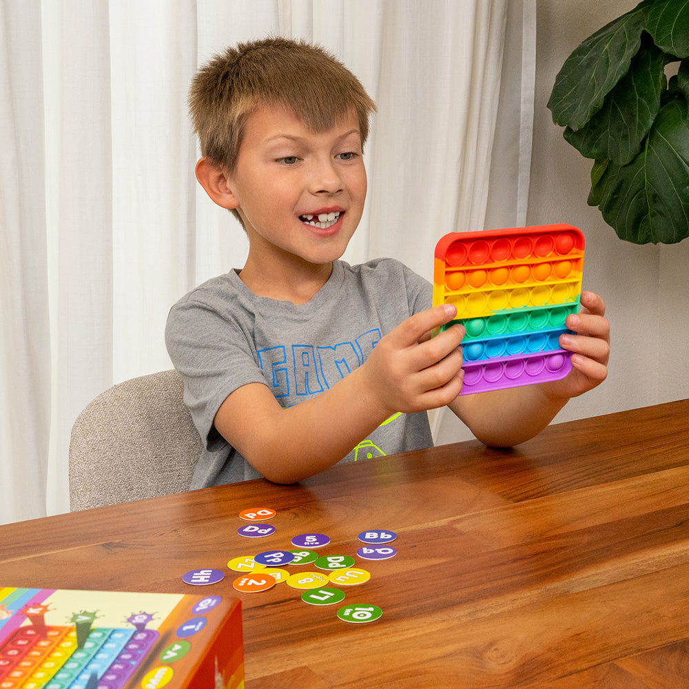 Kid Engaging with ABC Pop & Match Bingo 