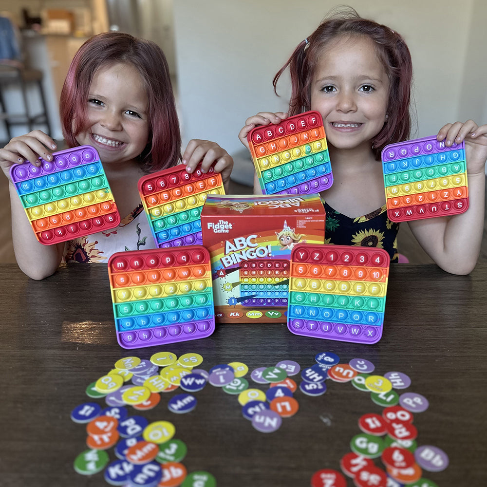 Two Kids Posing with 115-Piece ABC Bingo Set