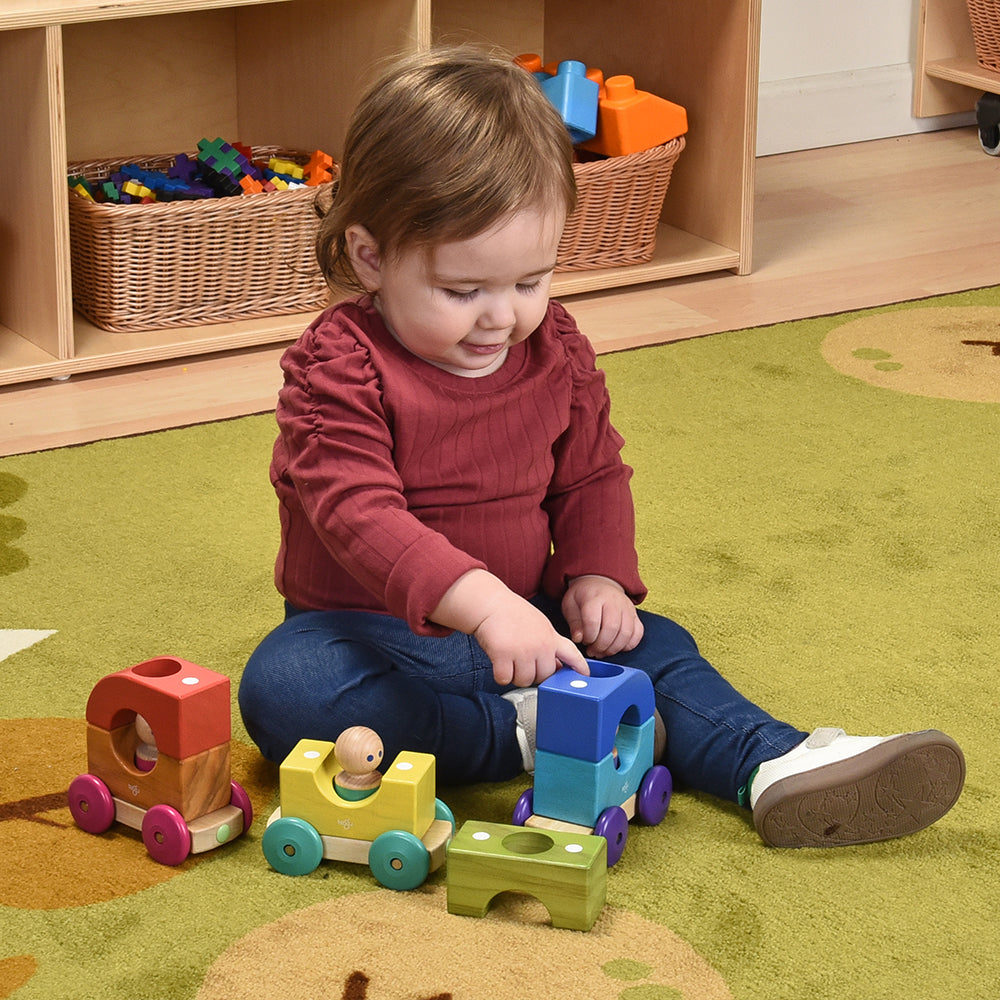 Toddler Interacting with Tegu Magnetic Tram in the classroom