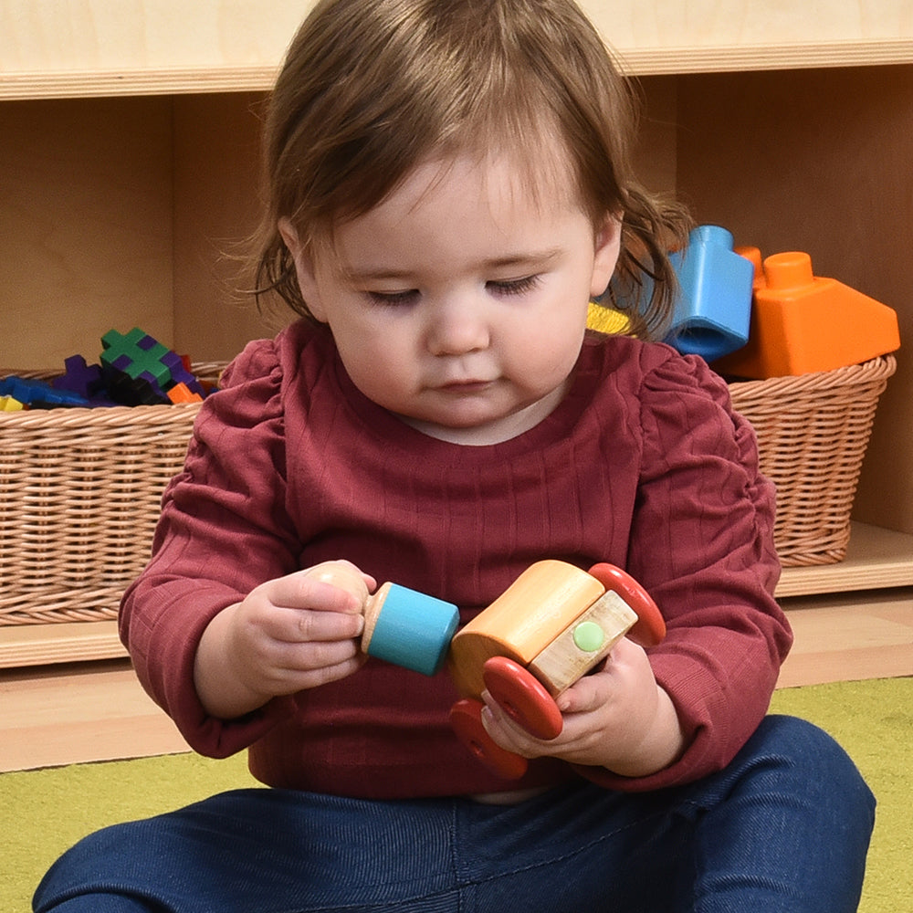 Toddler Engaging with Tegu Orange Magnetic Racer