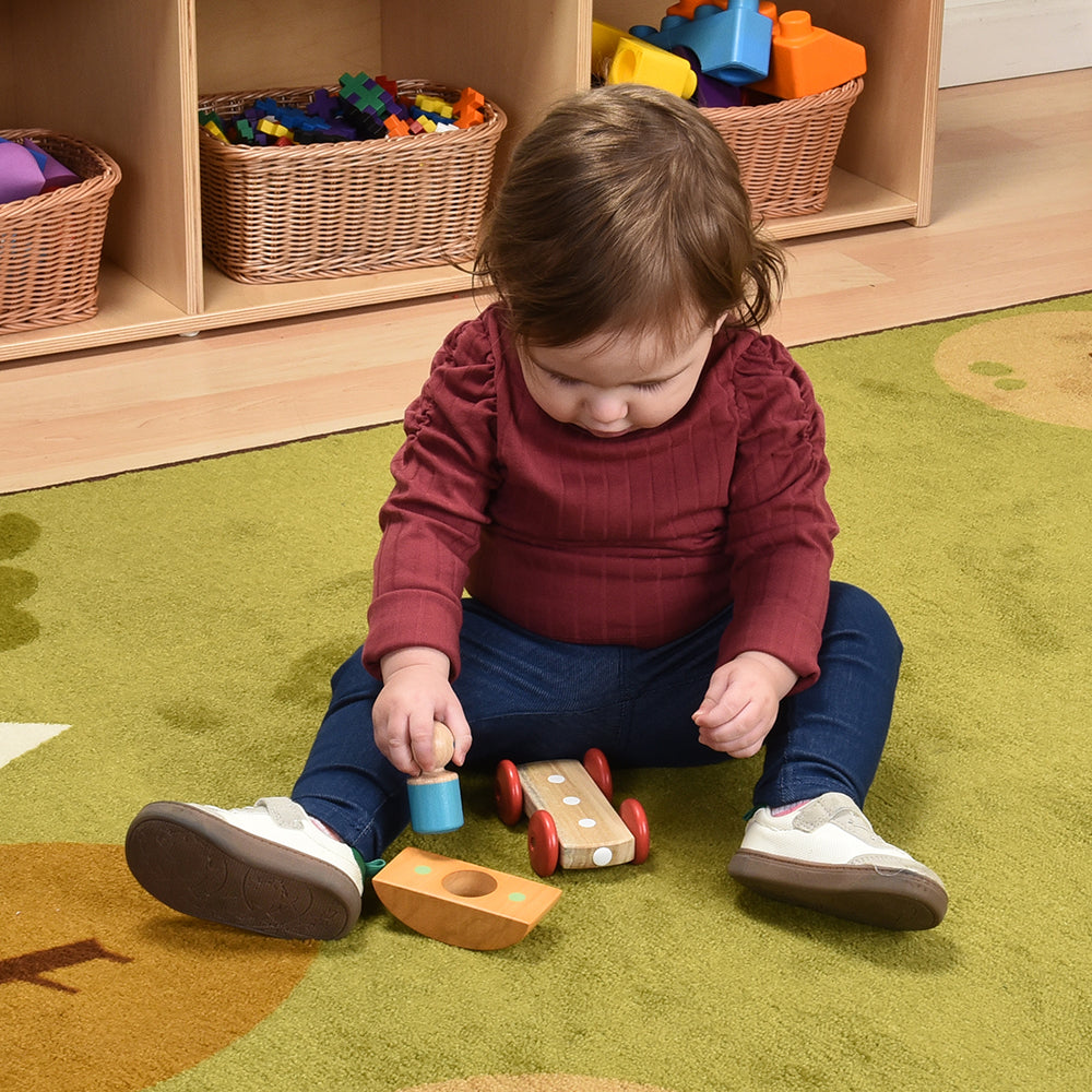 Toddler Playing with Tegu Orange Magnetic Racer