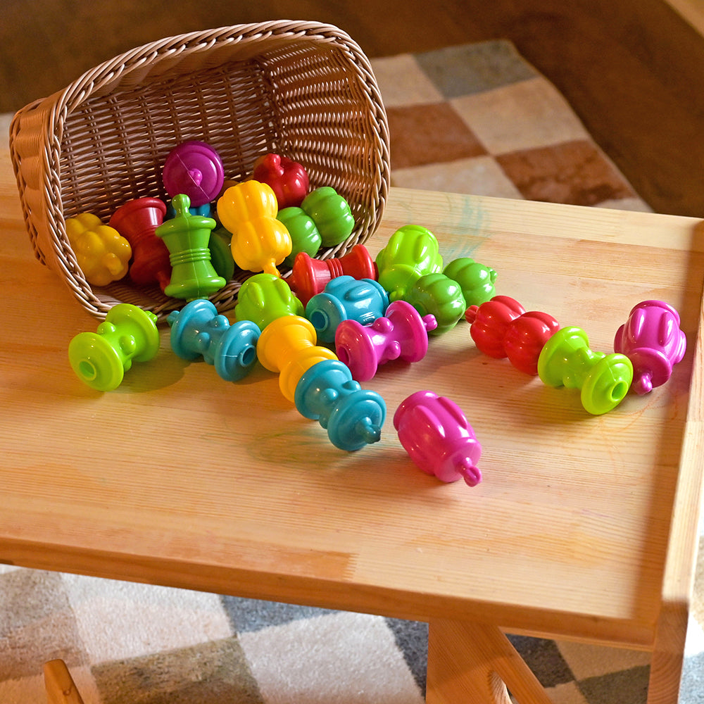 Snap beads Spilling Out of the Basket on the Table in Classroom