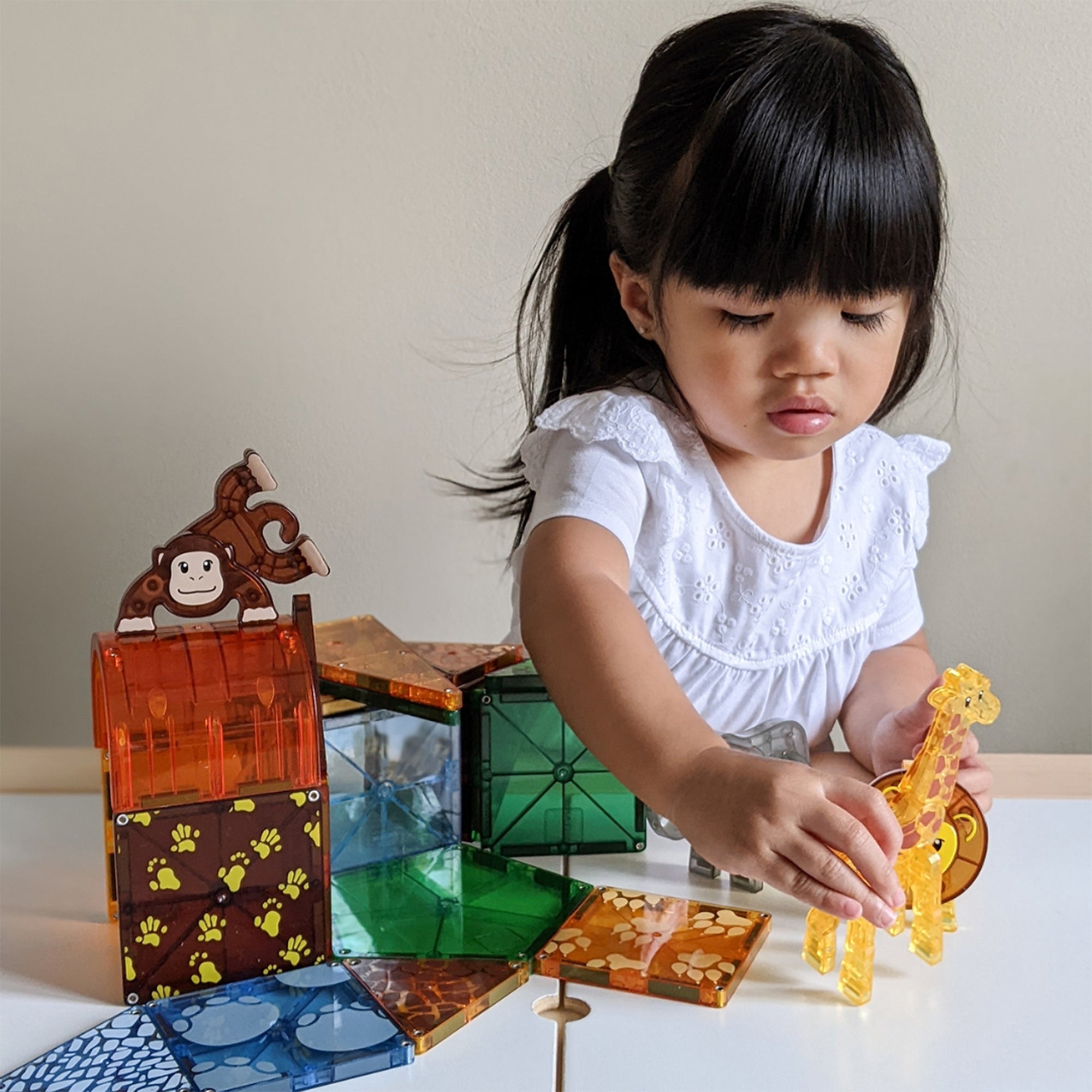 Child playing with colorful building blocks on a table