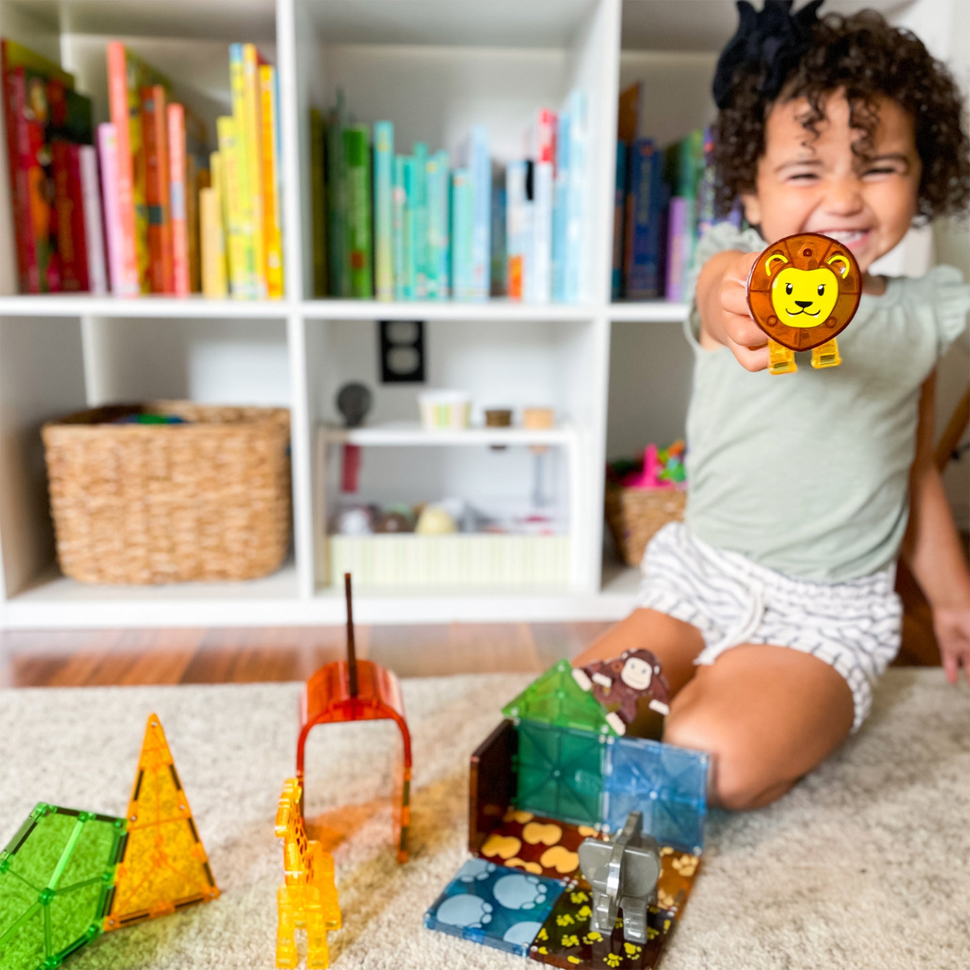 Child playing with toy blocks in a room with bookshelves in the background