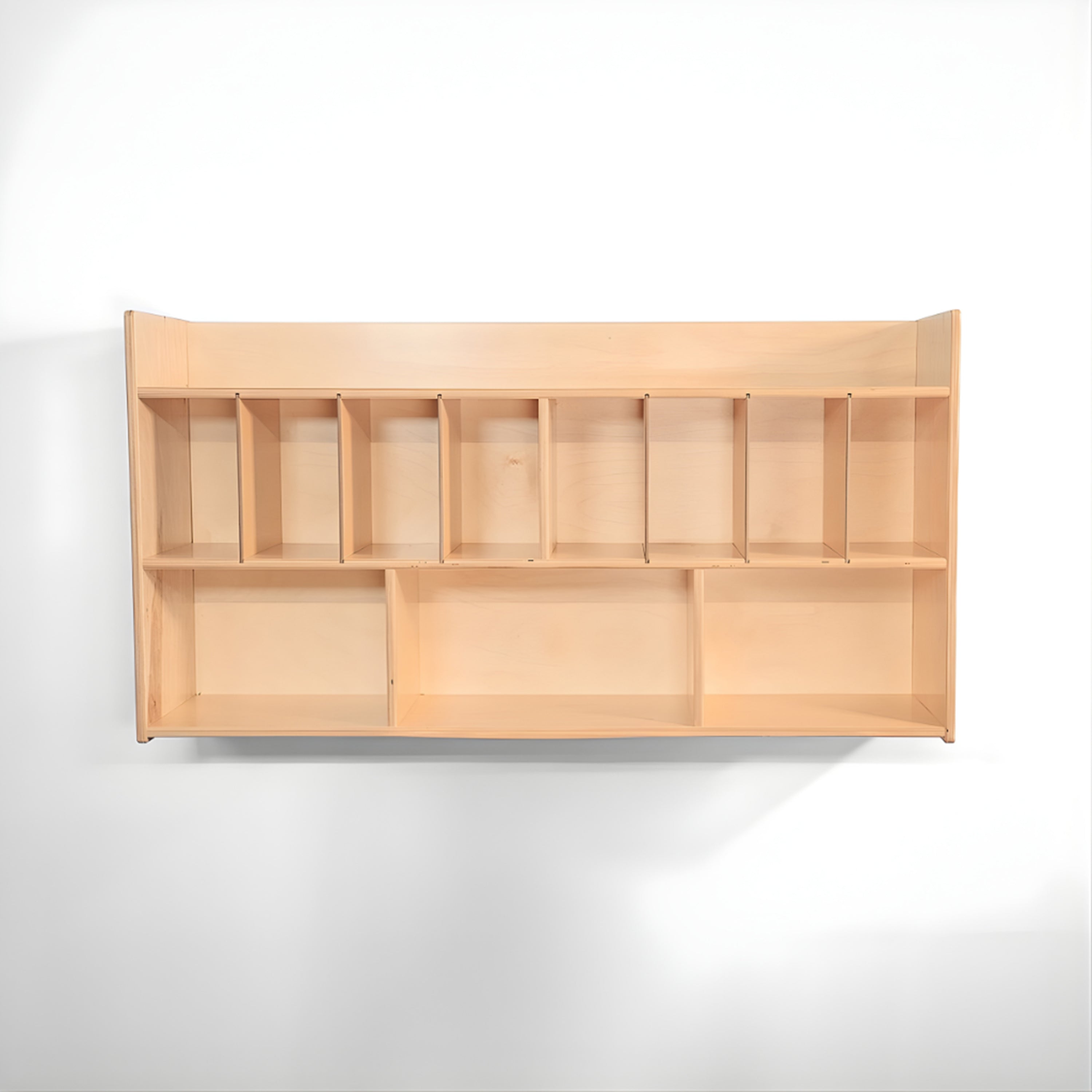 Wooden wall-mounted shelf with multiple compartments on a white background