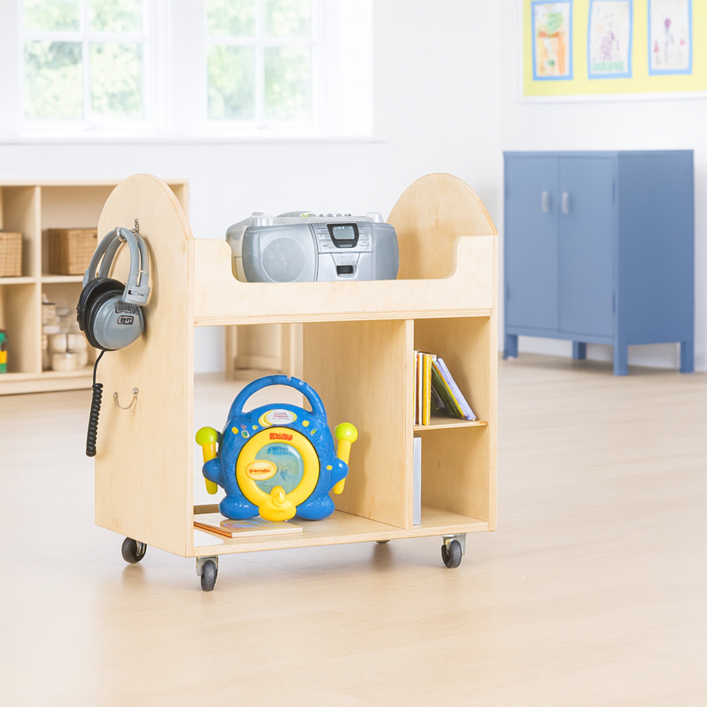 Wooden cart with educational toys in a classroom setting