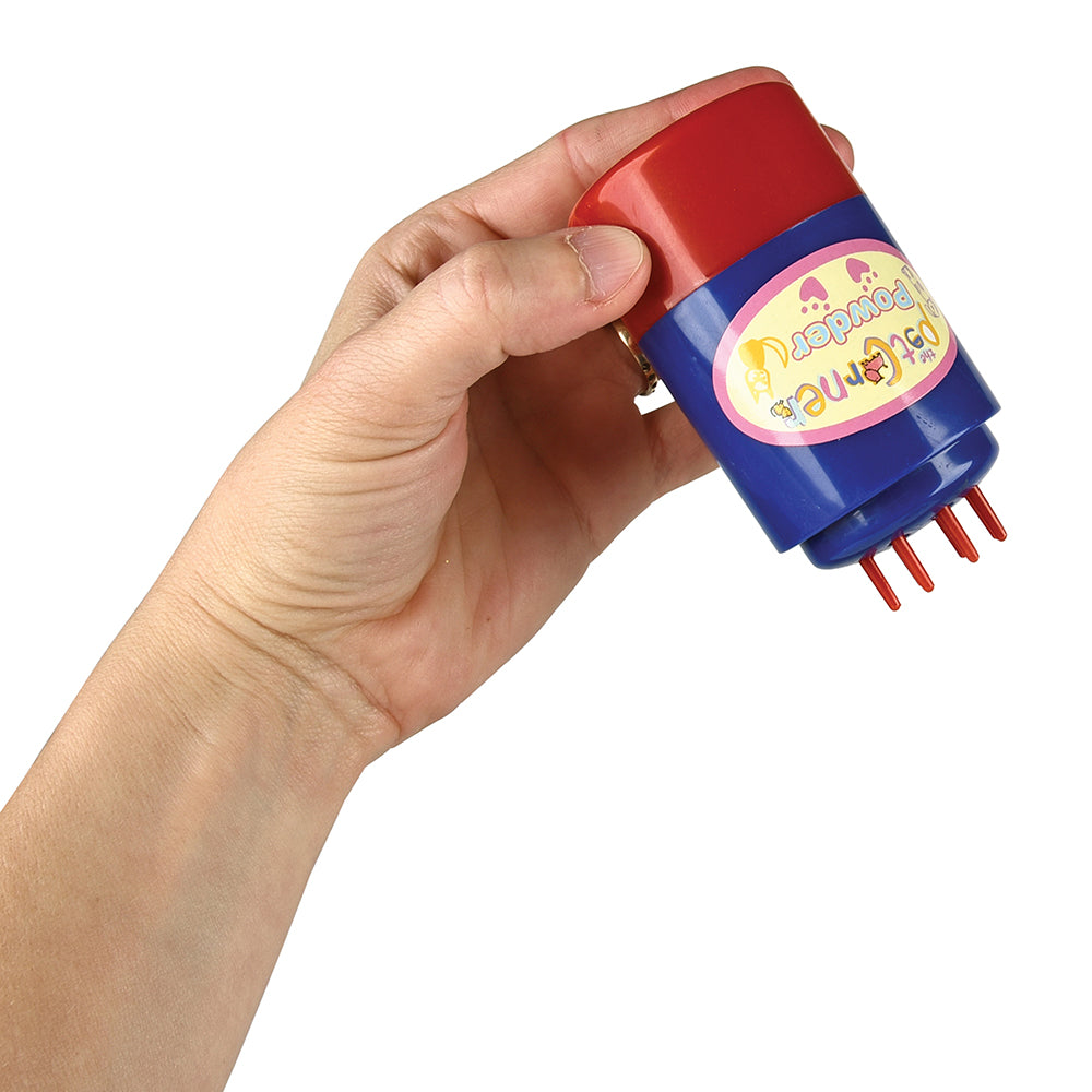 Hand holding a red and blue toy with a colorful label on a white background