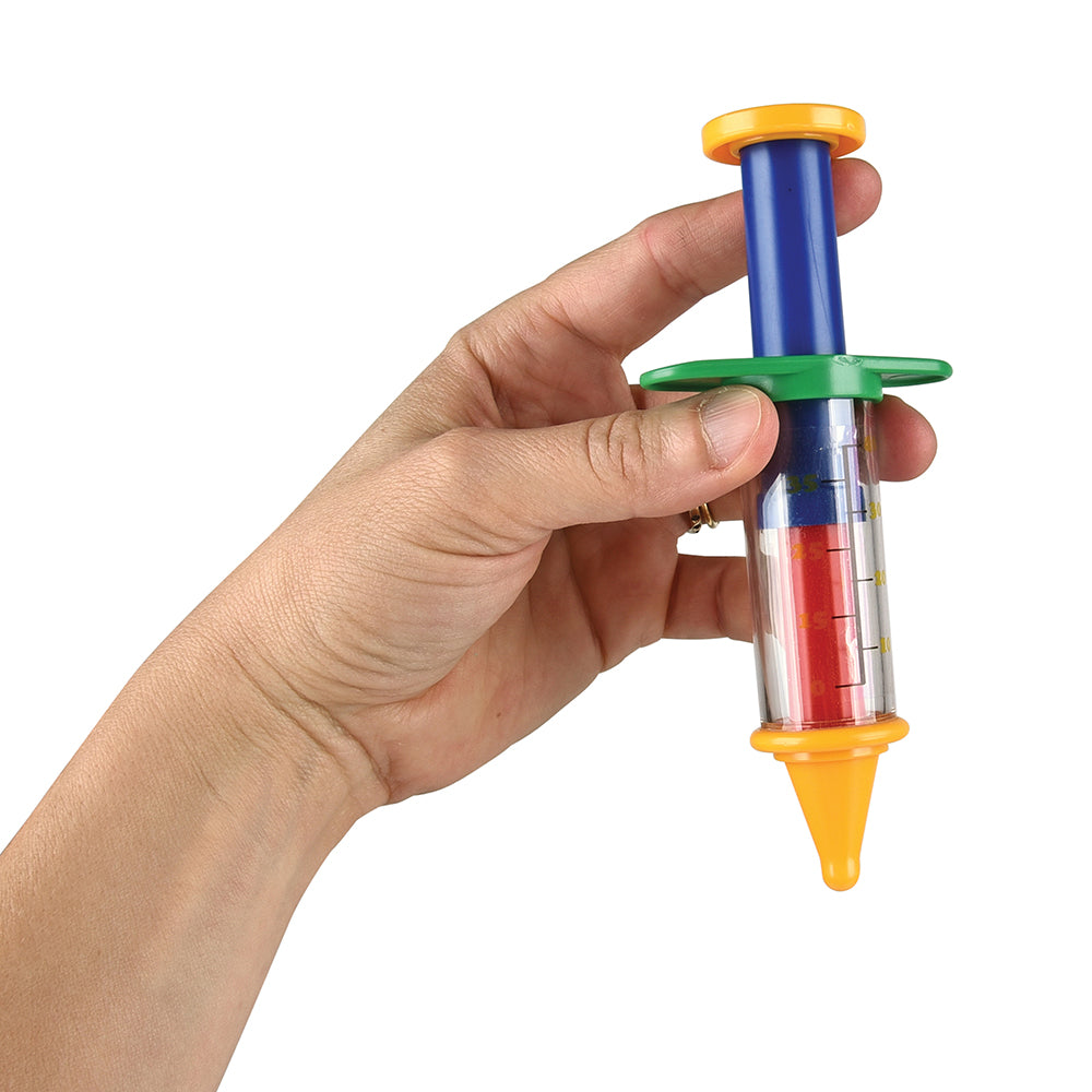 Hand holding a colorful syringe-like toy tool with a white background