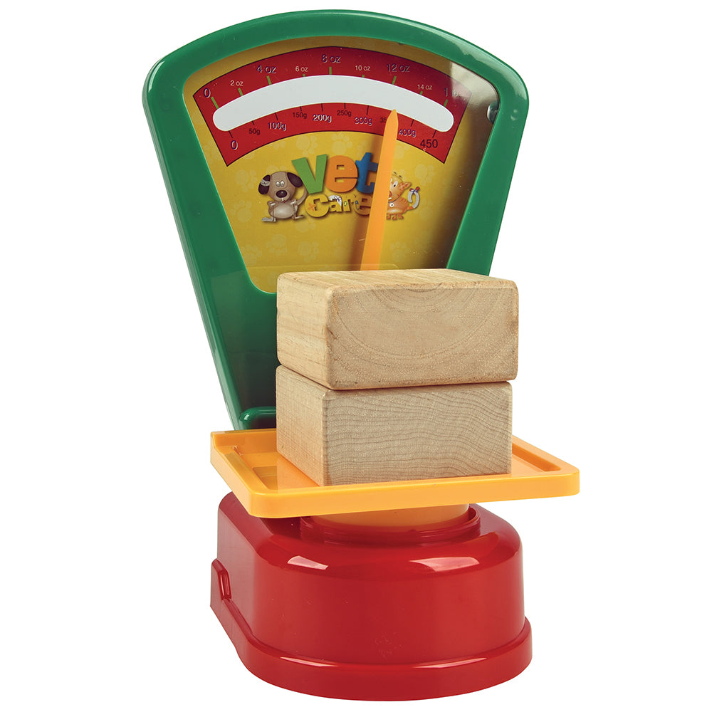 Toy scale with wooden blocks on a white background