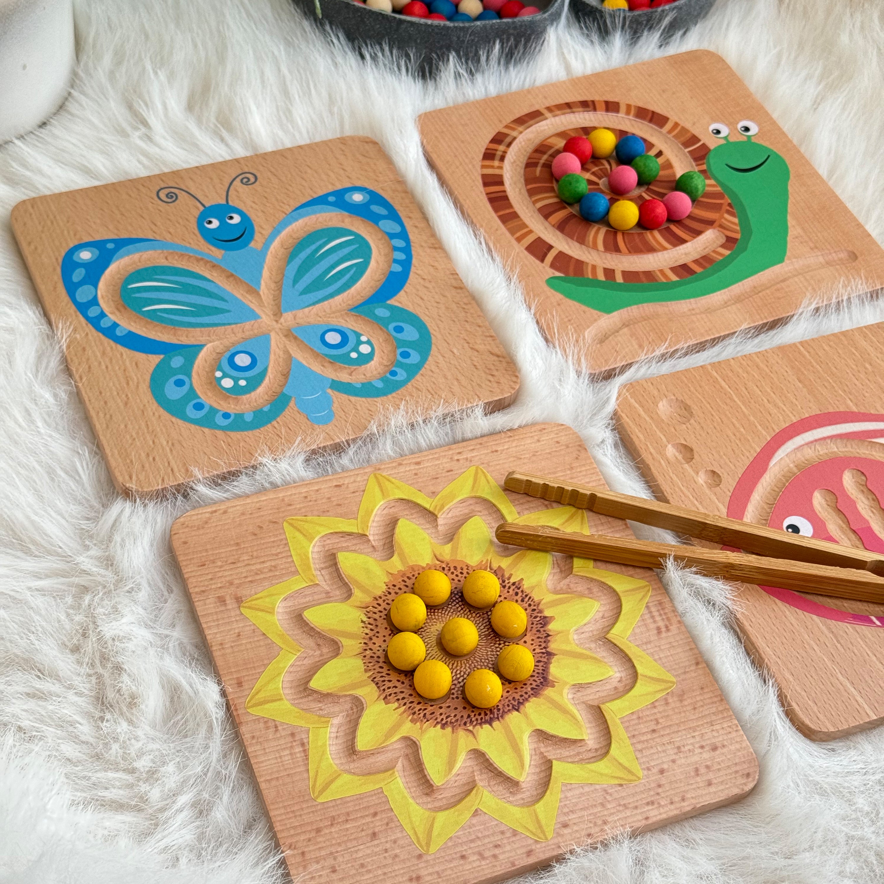 Wooden toys with colorful beads on a fluffy white surface