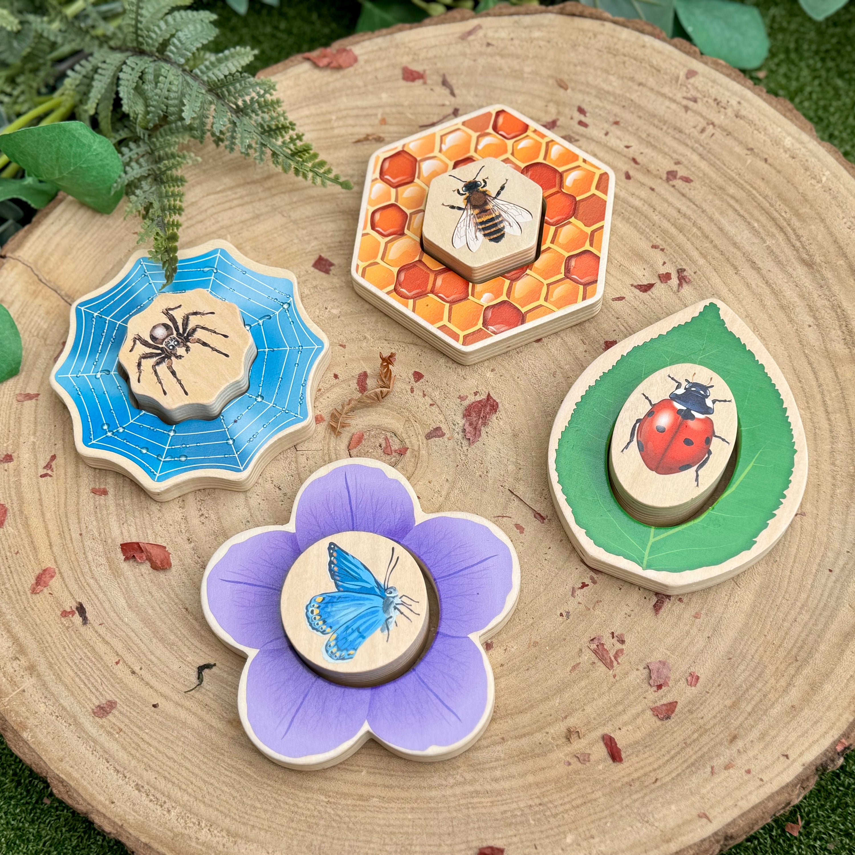 Set of wooden puzzles with nature-themed designs on a wooden surface.