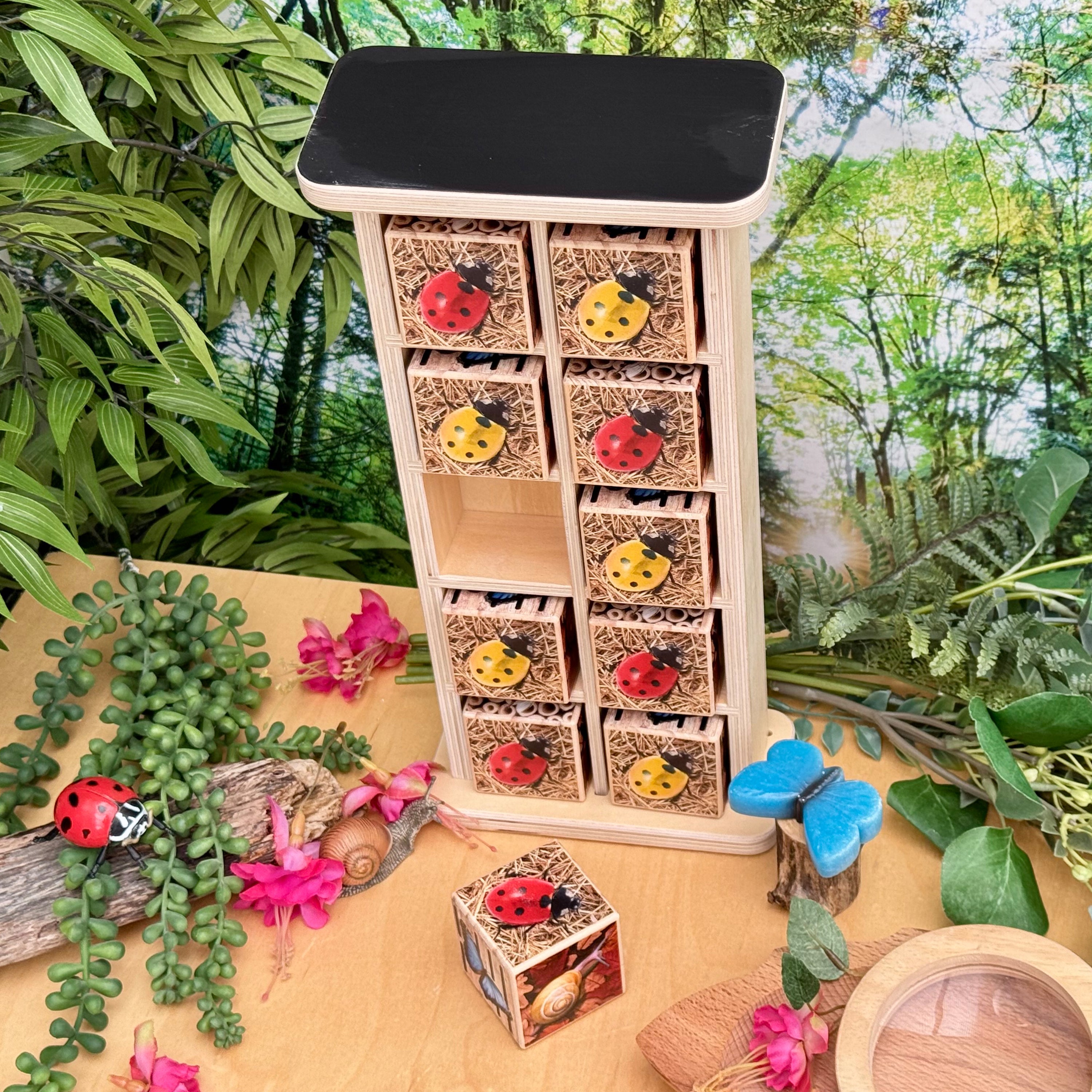 Wooden insect house with ladybug designs on a natural setting